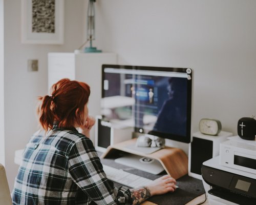 Focused woman structuring layout blocks on a screen display